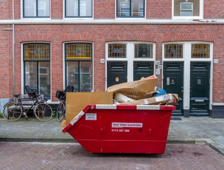 People assessing old furniture for disposal